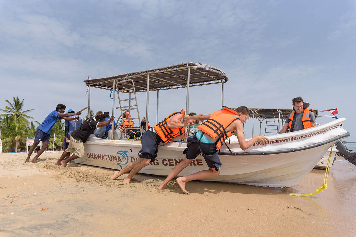 pushing diving boats to the sea in Sri Lanka