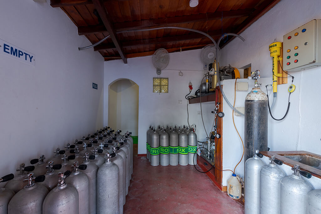 compressor room with scuba tanks and BAUER compressor