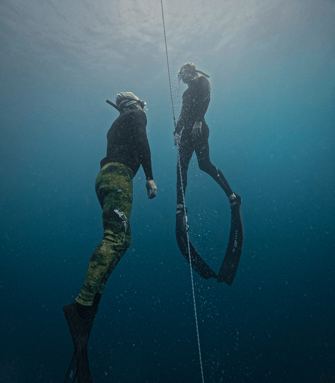 constant weight freediving on a line with a lanyard, safety diver securing the deep dive in Sri Lanka